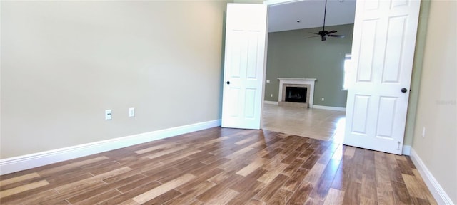 5595 Schefflera, Grant, FL 32949 - unfurnished room featuring wood finished floors, a ceiling fan, and a fireplace