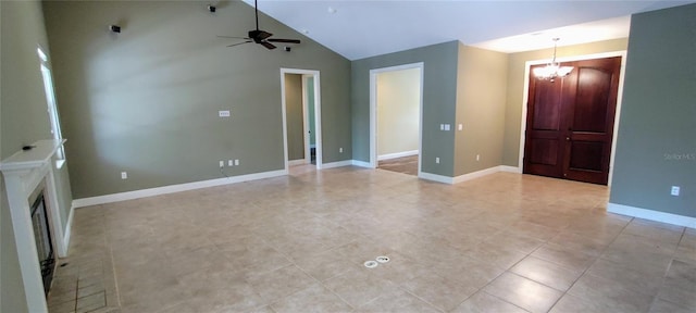 5595 Schefflera, Grant, FL 32949 - unfurnished living room featuring a chandelier, ceiling fan, light tile patterned flooring, lofted ceiling, and a fireplace