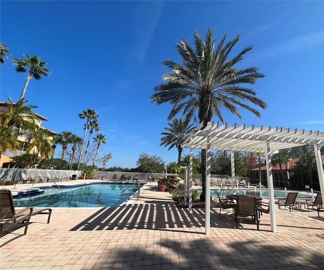 community pool featuring a pergola and a patio area