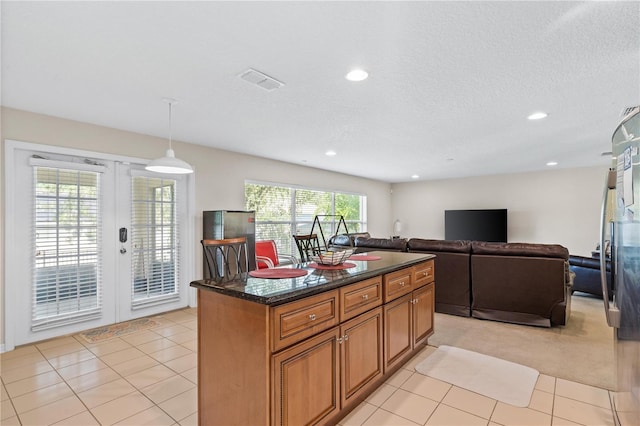 2613 Breezy Meadow Rd, Apopka, FL 32712 - kitchen featuring french doors, brown cabinetry, recessed lighting, light tile patterned flooring, and a center island