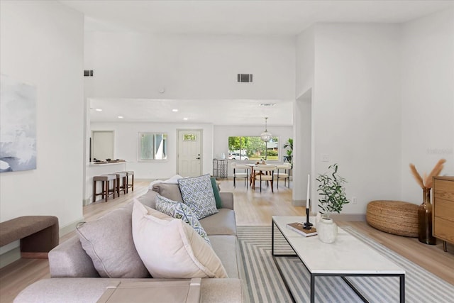 1030 Huntington Ct, Longwood, FL 32750 - living room with a towering ceiling, light wood-style flooring, and recessed lighting