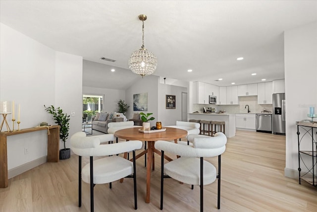 1030 Huntington Ct, Longwood, FL 32750 - dining space with a chandelier, light wood-type flooring, recessed lighting, and lofted ceiling