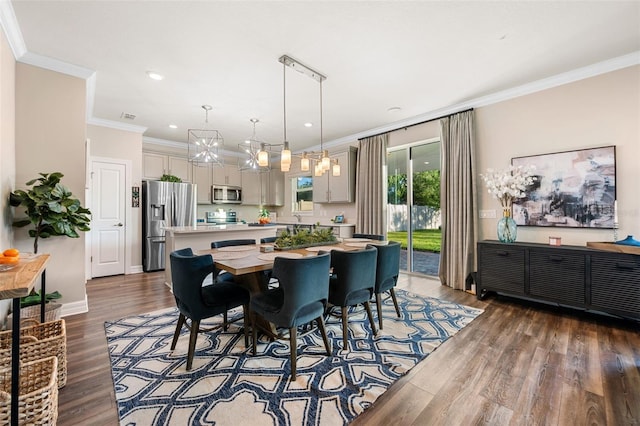 4316 Foggy Oak Ln, Sanford, FL 32773 - dining space with dark wood finished floors, ornamental molding, recessed lighting, and a chandelier