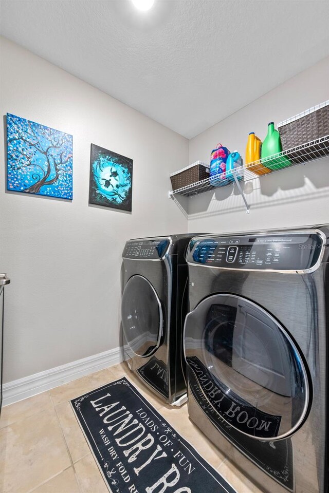4316 Foggy Oak Ln, Sanford, FL 32773 - laundry room with washing machine and dryer, tile patterned floors, and a textured ceiling