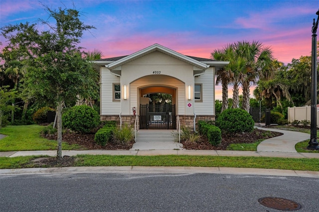 4316 Foggy Oak Ln, Sanford, FL 32773 - view of front facade with stone siding, a porch, and a gate