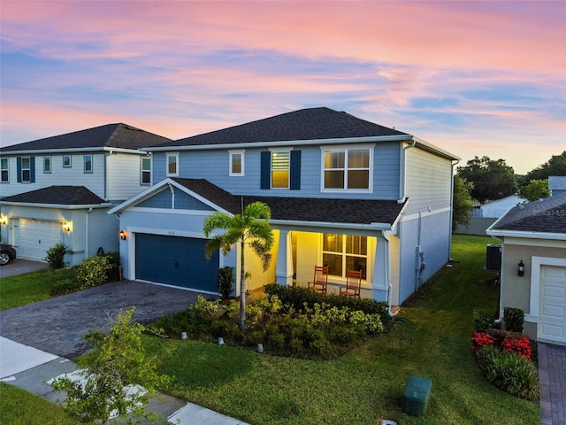 4316 Foggy Oak Ln, Sanford, FL 32773 - view of front of house with an attached garage, driveway, a front yard, covered porch, and roof with shingles