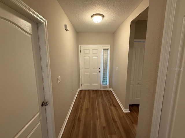 4792 Summerfield Cir, Winter Haven, FL 33881 - doorway to outside with wood finished floors and a textured ceiling