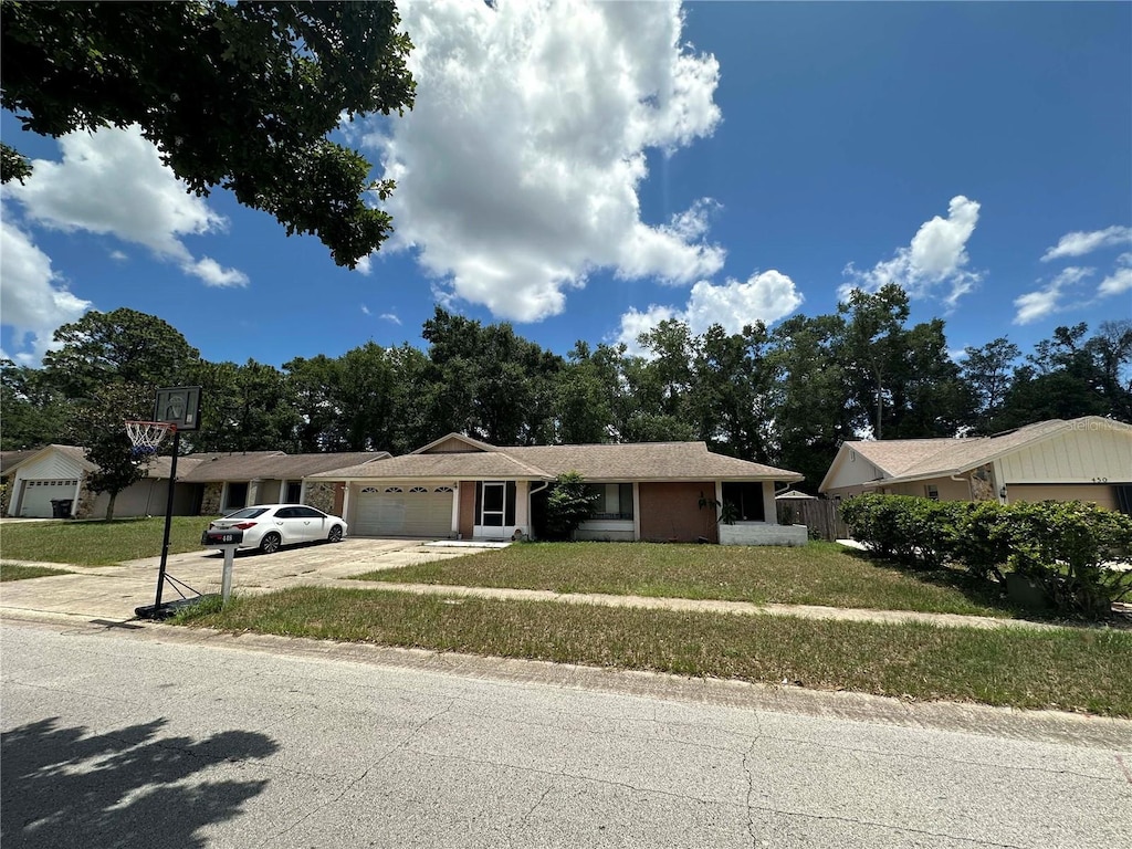 448 S Meander Dr, Altamonte Springs, FL 32714 - ranch-style home featuring an attached garage, a front yard, and driveway