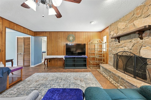 1515 Colonist Ct, Orlando, FL 32818 - living area featuring wood walls, a textured ceiling, ceiling fan, and a fireplace