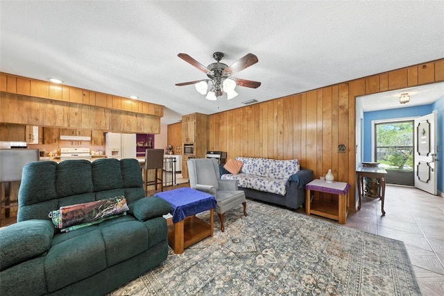 1515 Colonist Ct, Orlando, FL 32818 - living area featuring wood walls, ceiling fan, a textured ceiling, and recessed lighting