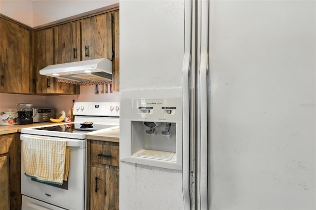 1515 Colonist Ct, Orlando, FL 32818 - kitchen with under cabinet range hood, white appliances, brown cabinets, and light countertops
