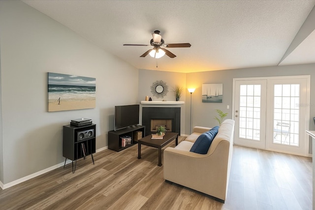 2550 Alafaya Trl Unit 9303, Orlando, FL 32826 - living area with ceiling fan, lofted ceiling, wood finished floors, and a fireplace