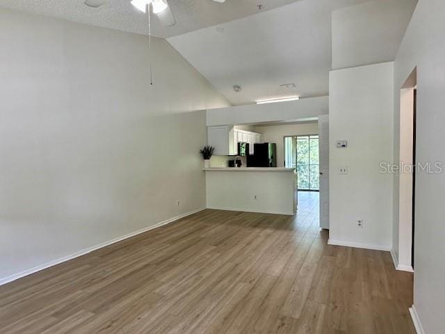 125 Reserve Cir Unit 205, Oviedo, FL 32765 - unfurnished living room with a ceiling fan, wood finished floors, and lofted ceiling
