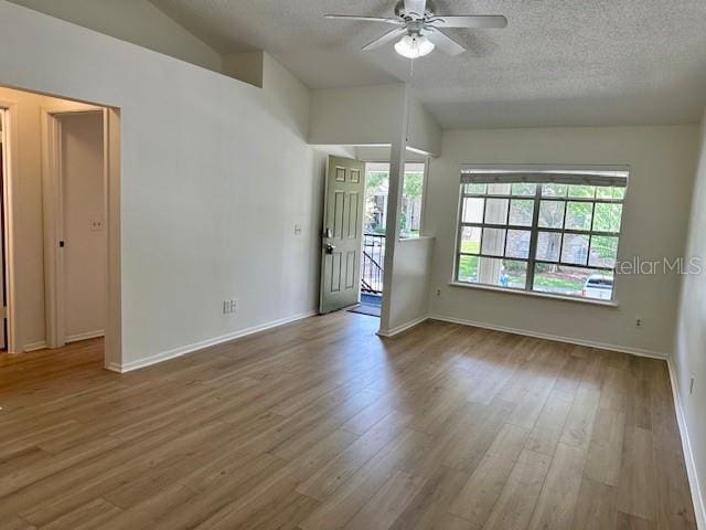 125 Reserve Cir Unit 205, Oviedo, FL 32765 - spare room with a ceiling fan, lofted ceiling, a textured ceiling, and wood finished floors