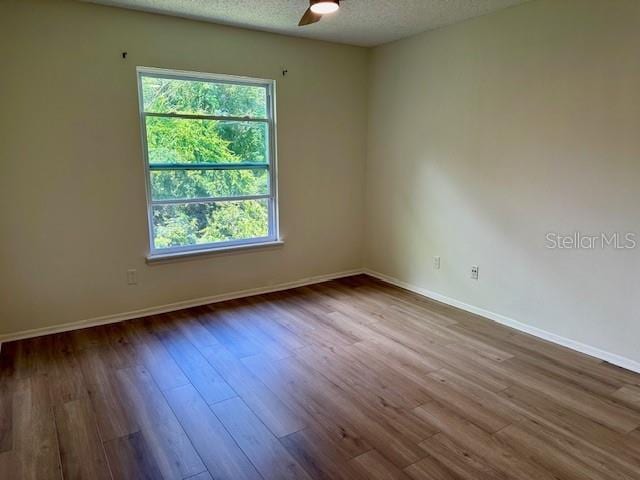 125 Reserve Cir Unit 205, Oviedo, FL 32765 - empty room featuring ceiling fan, wood finished floors, and a textured ceiling
