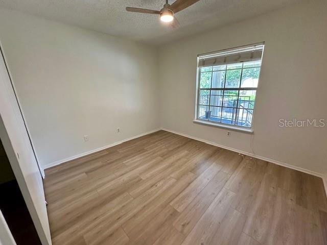 125 Reserve Cir Unit 205, Oviedo, FL 32765 - unfurnished room with a ceiling fan, wood finished floors, and a textured ceiling