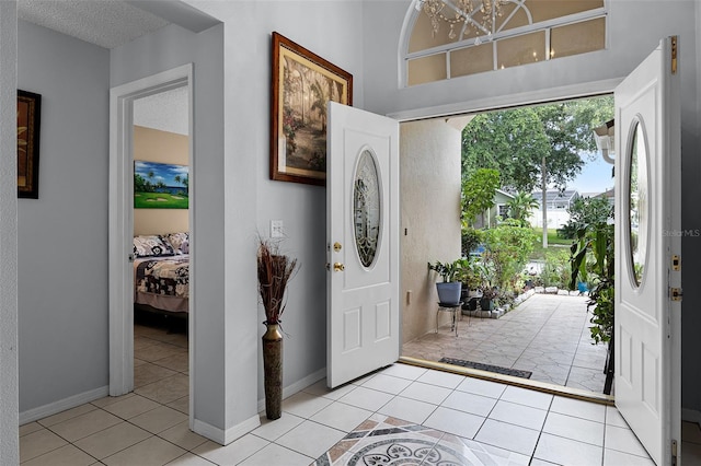 527 Durango Loop St, Davenport, FL 33897 - foyer featuring light tile patterned floors and a chandelier