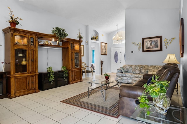 527 Durango Loop St, Davenport, FL 33897 - living area featuring light tile patterned floors, a chandelier, and vaulted ceiling