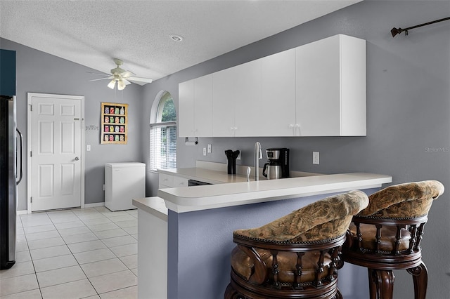 527 Durango Loop St, Davenport, FL 33897 - kitchen with refrigerator, freestanding refrigerator, light countertops, light tile patterned flooring, and a ceiling fan