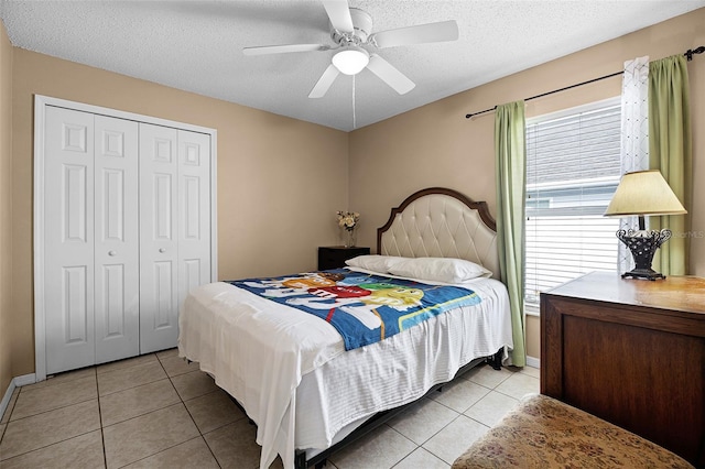 527 Durango Loop St, Davenport, FL 33897 - bedroom featuring light tile patterned flooring, a textured ceiling, a closet, and a ceiling fan