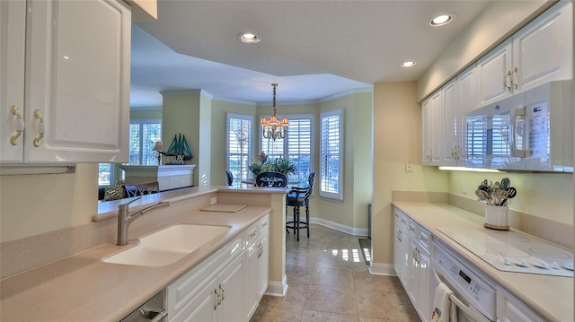 4626 Harbour Village Blvd Unit 3201, Ponce Inlet, FL 32127 - kitchen with white appliances, white cabinetry, light countertops, healthy amount of natural light, and ornamental molding