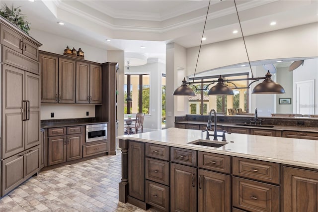 14315 80th Ave, Sebastian, FL 32958 - kitchen featuring crown molding, recessed lighting, light stone countertops, pendant lighting, and dark brown cabinetry