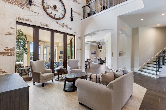 14315 80th Ave, Sebastian, FL 32958 - living area featuring arched walkways, a towering ceiling, french doors, stairs, and recessed lighting