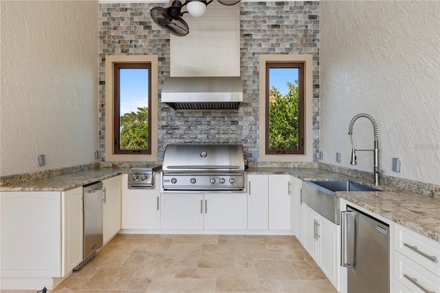14315 80th Ave, Sebastian, FL 32958 - kitchen with stone finish flooring, light stone countertops, custom range hood, white cabinets, and a textured wall
