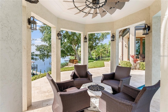 14315 80th Ave, Sebastian, FL 32958 - view of patio / terrace featuring ceiling fan, a fire pit, and a water view