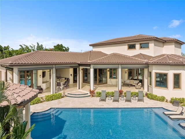 14315 80th Ave, Sebastian, FL 32958 - rear view of property with an outdoor pool, a patio area, a tile roof, and an outdoor hangout area