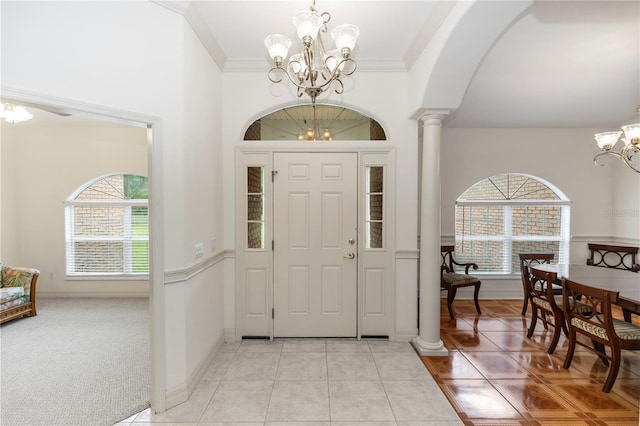 1908 S Farm Rd, Deland, FL 32720 - entryway with a chandelier, light tile patterned floors, ornate columns, crown molding, and arched walkways