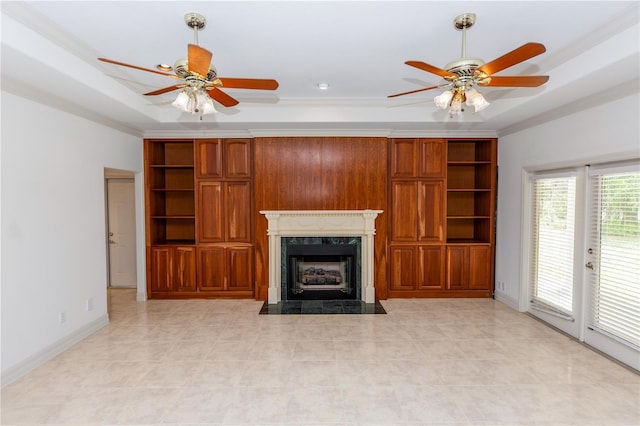 1908 S Farm Rd, Deland, FL 32720 - unfurnished living room with a ceiling fan, a fireplace, a tray ceiling, and light tile patterned flooring