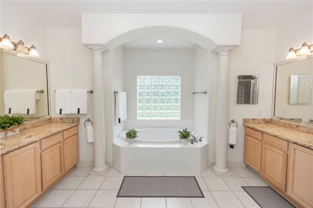 1908 S Farm Rd, Deland, FL 32720 - full bath featuring ornate columns, two vanities, a garden tub, and tile patterned flooring