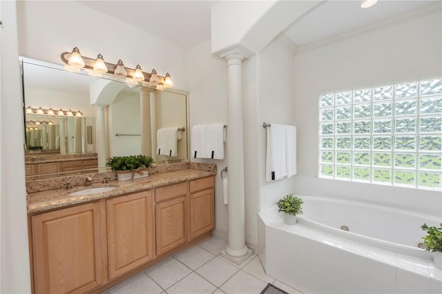 1908 S Farm Rd, Deland, FL 32720 - bathroom with ornate columns, double vanity, a jetted tub, and tile patterned floors