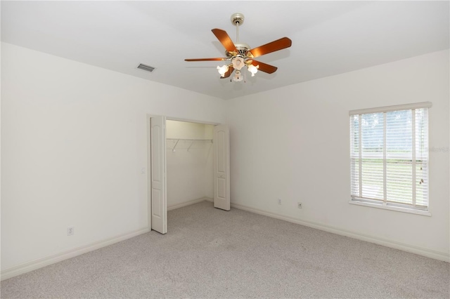 1908 S Farm Rd, Deland, FL 32720 - unfurnished bedroom featuring light colored carpet, a closet, and a ceiling fan