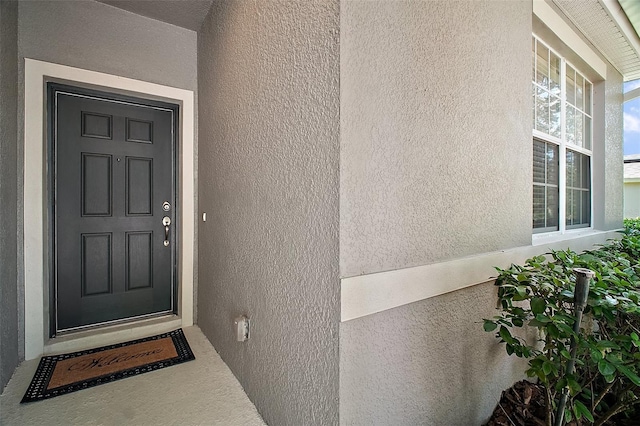 5116 Tempic Dr, Mount Dora, FL 32757 - doorway to property featuring stucco siding