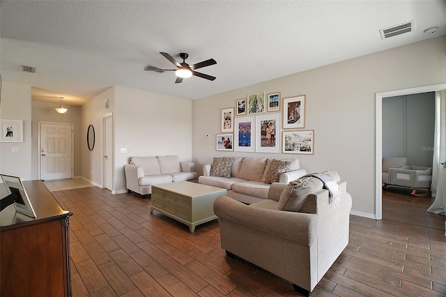 5116 Tempic Dr, Mount Dora, FL 32757 - living room featuring ceiling fan, dark wood-style floors, and a textured ceiling
