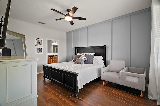 5116 Tempic Dr, Mount Dora, FL 32757 - bedroom with a decorative wall, dark wood-style flooring, ceiling fan, and ensuite bathroom