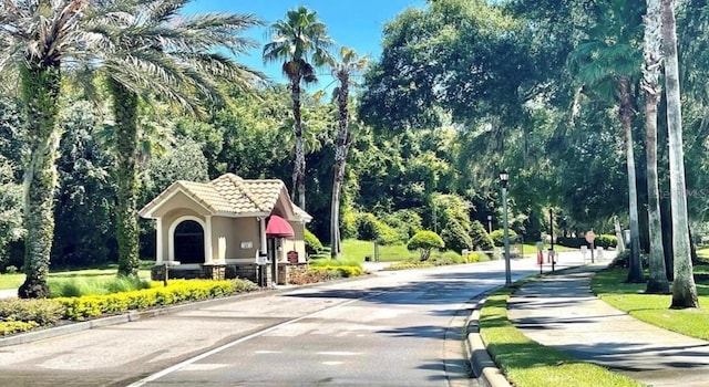 5116 Tempic Dr, Mount Dora, FL 32757 - view of asphalt street featuring street lighting, curbs, and sidewalks