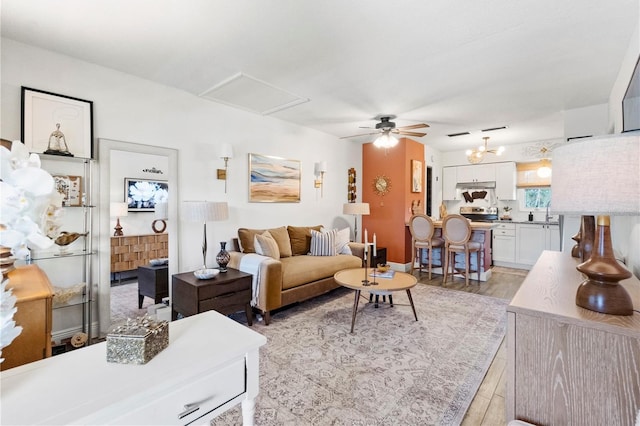 1100 E Caroline St Unit 204, Tavares, FL 32778 - living room featuring ceiling fan, light wood-style floors, and attic access