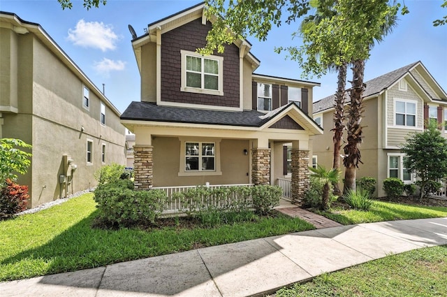 1110 Pine Falls Ln, Ocoee, FL 34761 - craftsman-style house featuring covered porch, stone siding, a shingled roof, and stucco siding