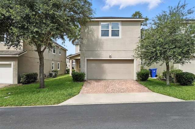 1110 Pine Falls Ln, Ocoee, FL 34761 - traditional home featuring decorative driveway, stucco siding, a garage, and a front yard