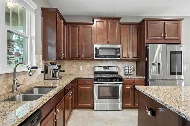 1110 Pine Falls Ln, Ocoee, FL 34761 - kitchen with stainless steel appliances, backsplash, light stone counters, and light tile patterned flooring