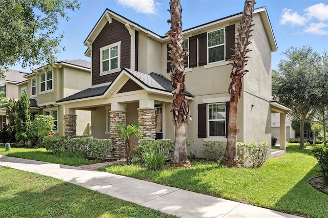 1110 Pine Falls Ln, Ocoee, FL 34761 - view of front of home with a front yard, stucco siding, and stone siding