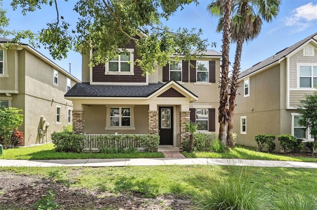 1110 Pine Falls Ln, Ocoee, FL 34761 - view of front of home with stone siding, a porch, a front yard, and stucco siding