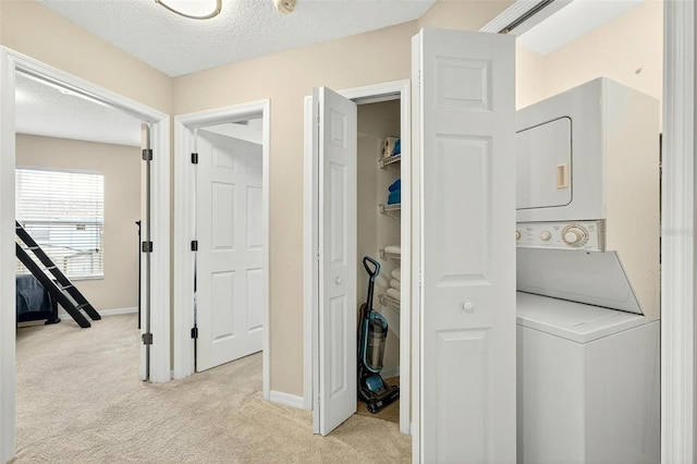 4558 Baleno Ln, Kissimmee, FL 34746 - laundry room featuring estacked washer and dryer, light colored carpet, and a textured ceiling