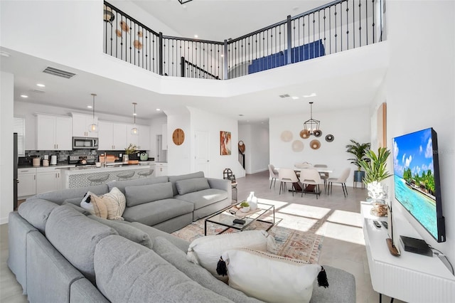 9175 Sommerset Hills Dr, Davenport, FL 33896 - living room featuring a high ceiling, a chandelier, and recessed lighting