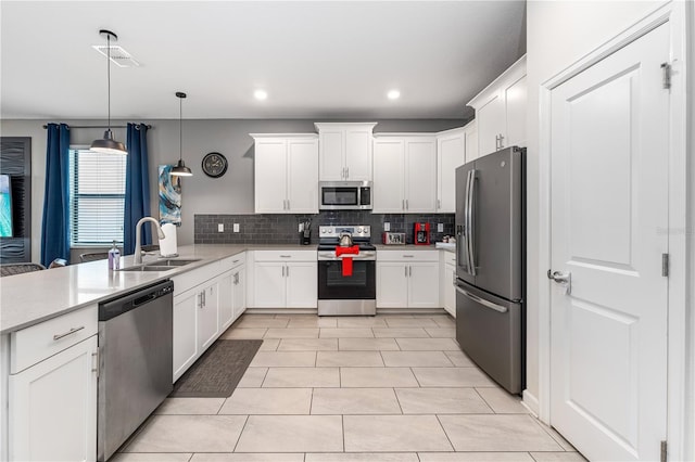 2907 Fable St, Kissimmee, FL 34746 - kitchen featuring stainless steel appliances, a peninsula, backsplash, white cabinetry, and recessed lighting