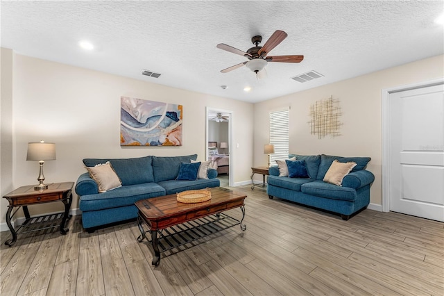 2907 Fable St, Kissimmee, FL 34746 - living room with a ceiling fan, light wood-type flooring, a textured ceiling, and recessed lighting