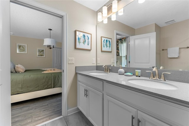 2907 Fable St, Kissimmee, FL 34746 - ensuite bathroom with double vanity and baseboards